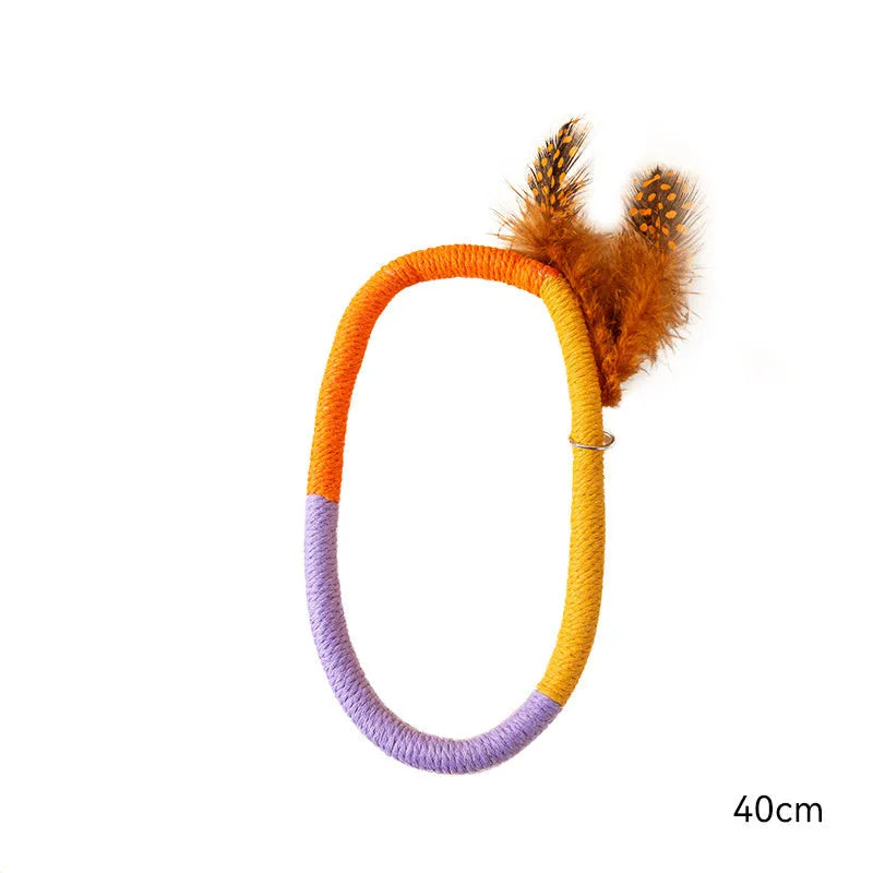 Green circular cotton rope cat toy with feathers for chewing and interactive play