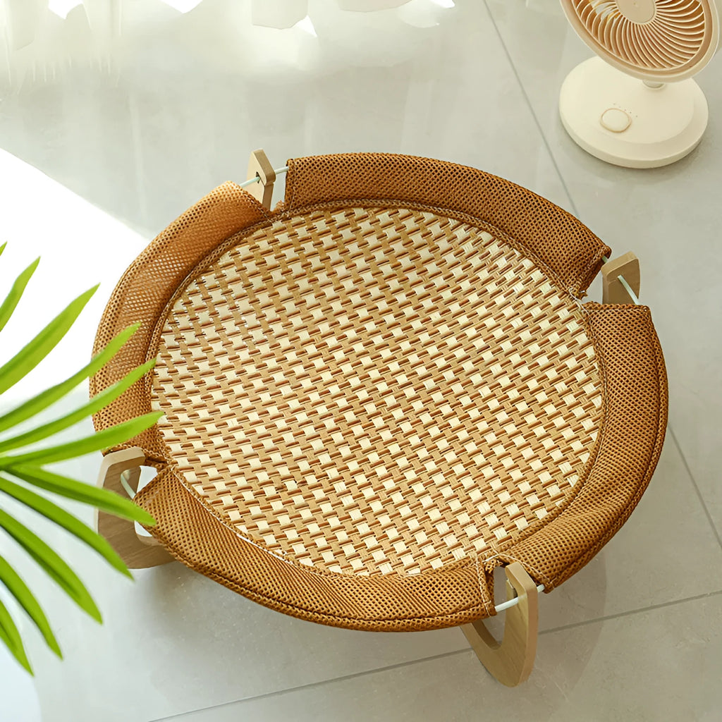 Brown woven rattan pet hammock bed raised off the ground