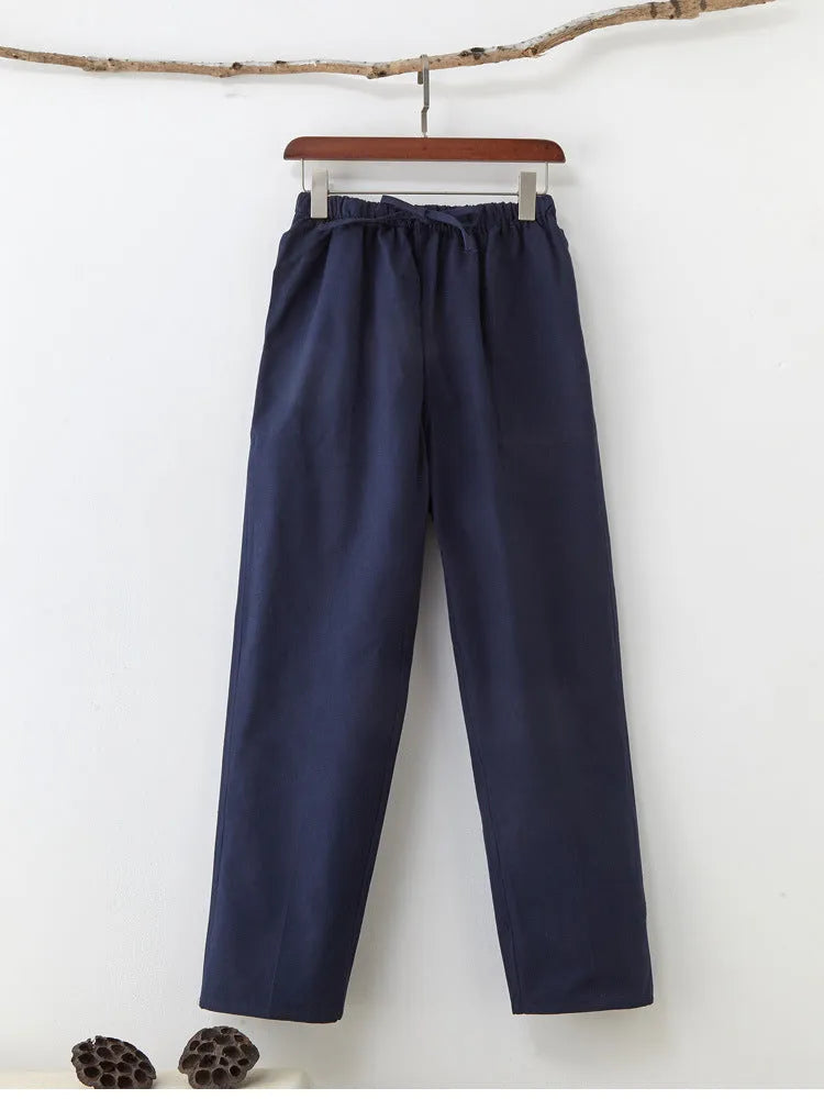 Men's beige pure cotton casual trousers with drawstring waist and belt on a neutral background.