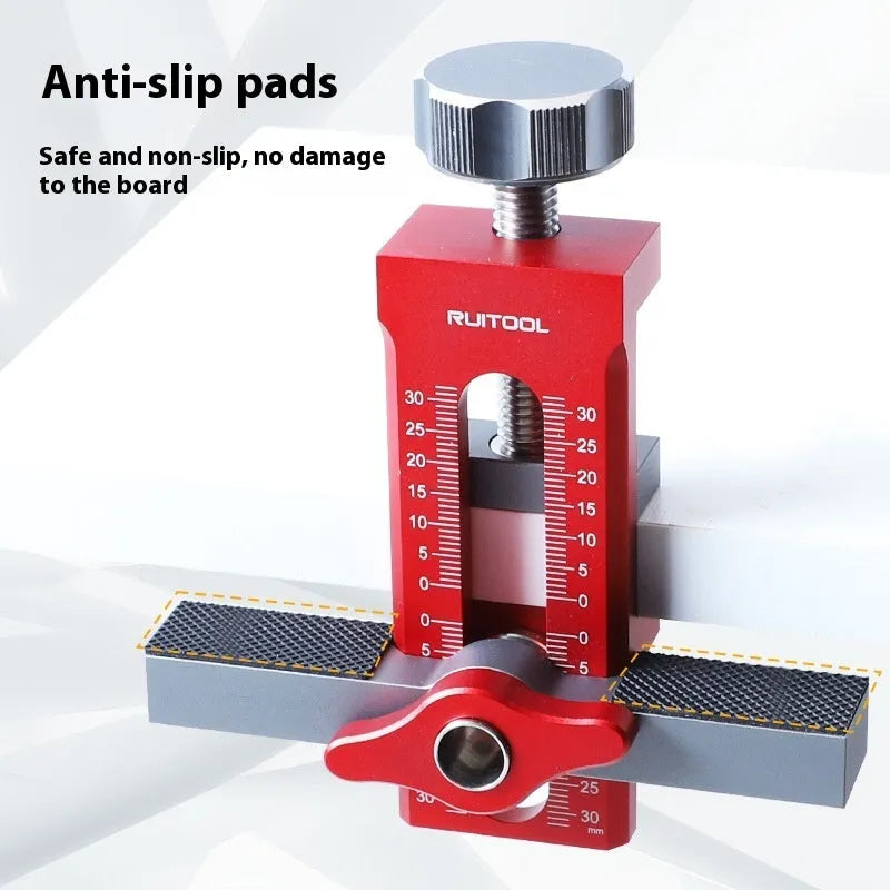 Aluminium alloy cabinet door installation aid tool for woodworking projects on a workbench.
