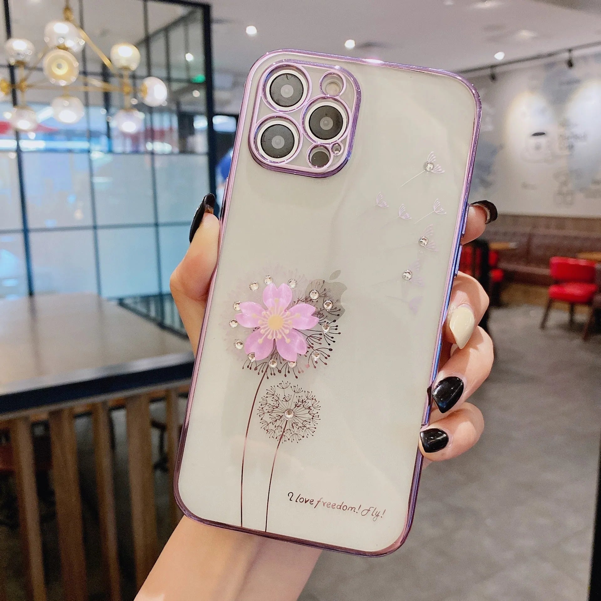 Green iPhone case with 3D floral design and extended kickstand on a table