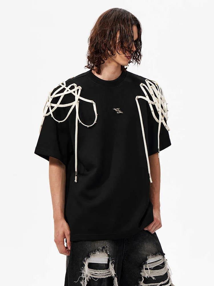 Black loose fit short-sleeved T-shirt with padded shoulders featuring rivet and ribbon detail.