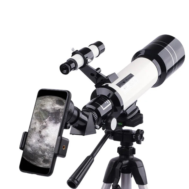 Dark blue children's astronomical telescope with adjustable magnification on a tripod, next to a mobile phone holder accessory.