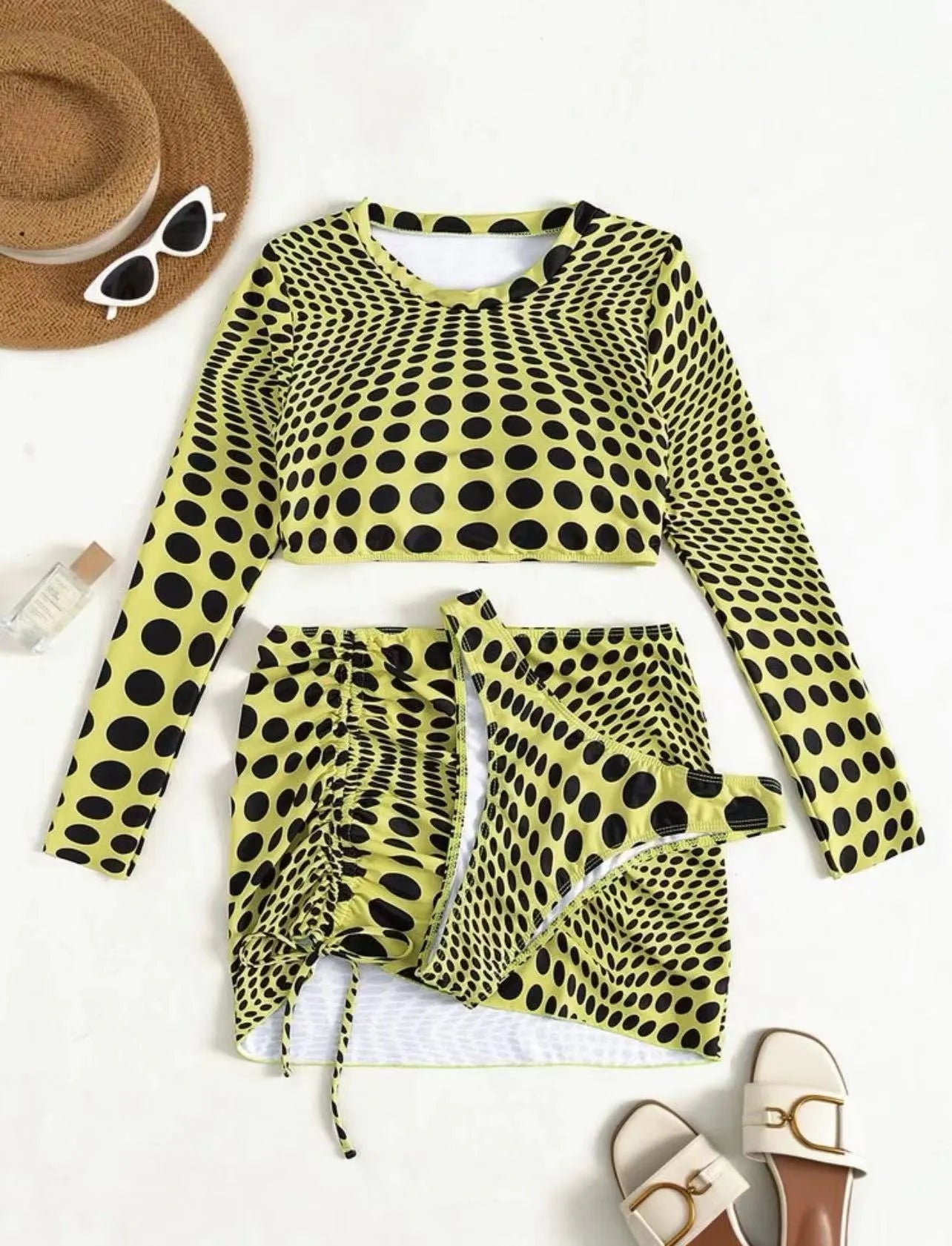 Green and yellow polka dot women's three-piece swimsuit set showing top, skirt, and bra.