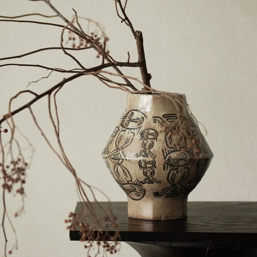 Hand-painted cylindrical ceramic vase with vintage carved tribal totem patterns in high or low style.