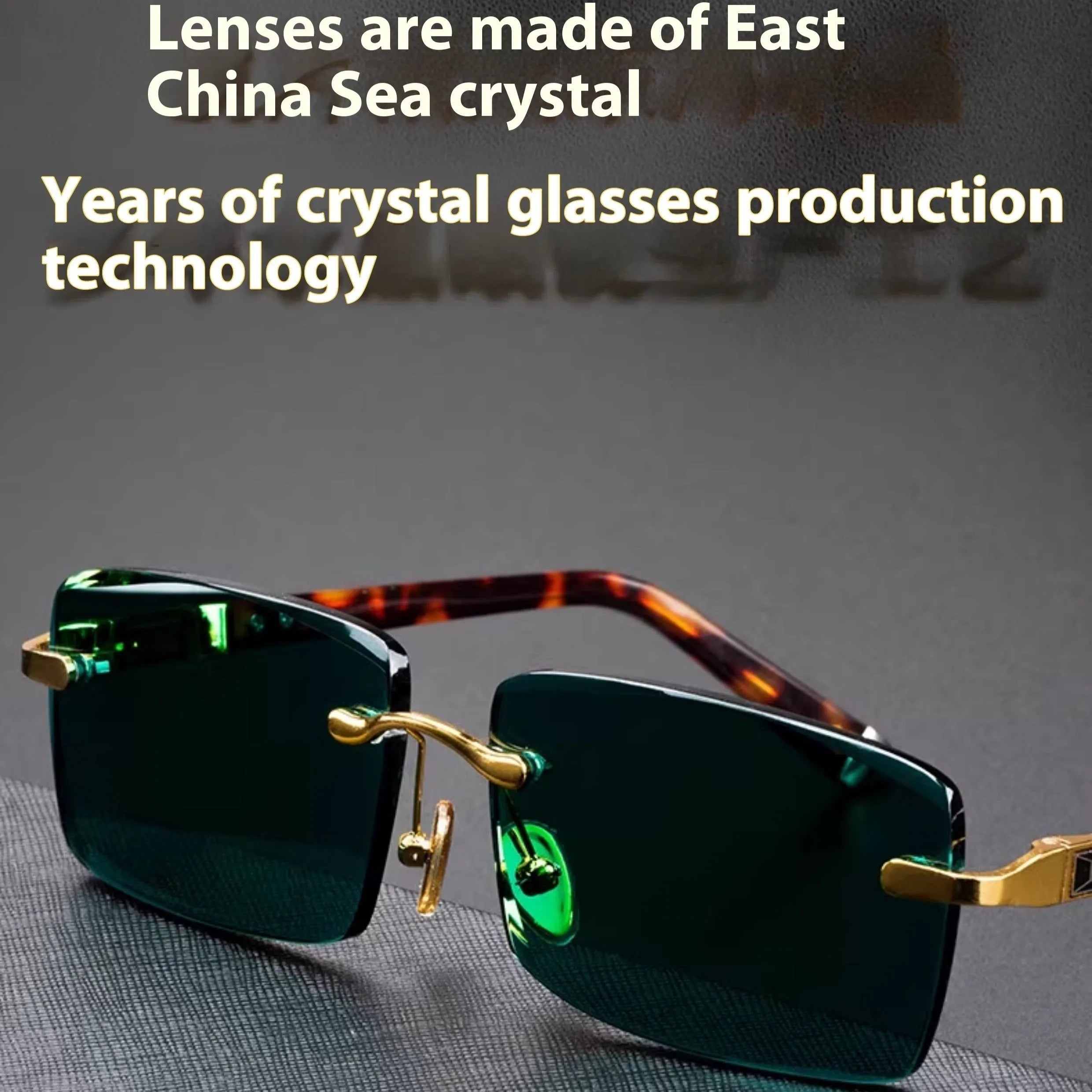 Frameless dark green crystal sunglasses with metal arms on a table next to their hard case.