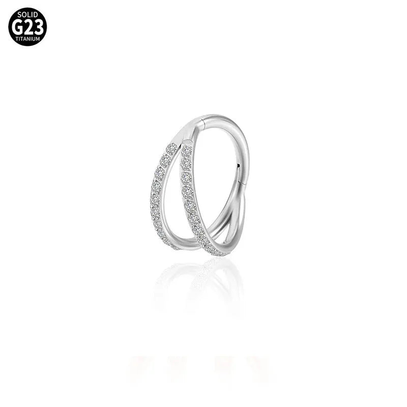 G23 titanium alloy puncture-style nose ring on a plain background showing steel and gold colour options.