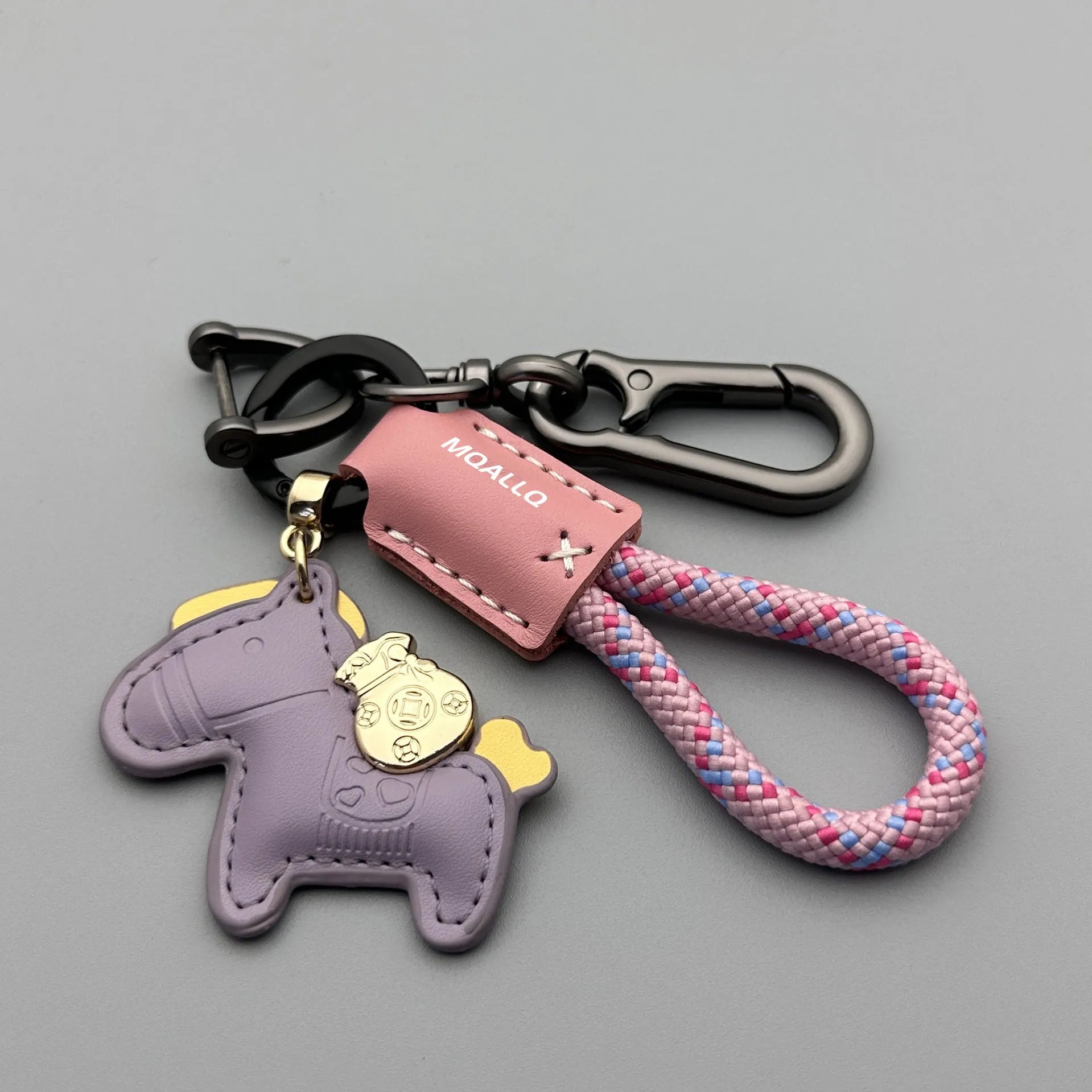 Handmade brown cowhide leather key ring with a zinc alloy pendant charm on a green flannel rope.