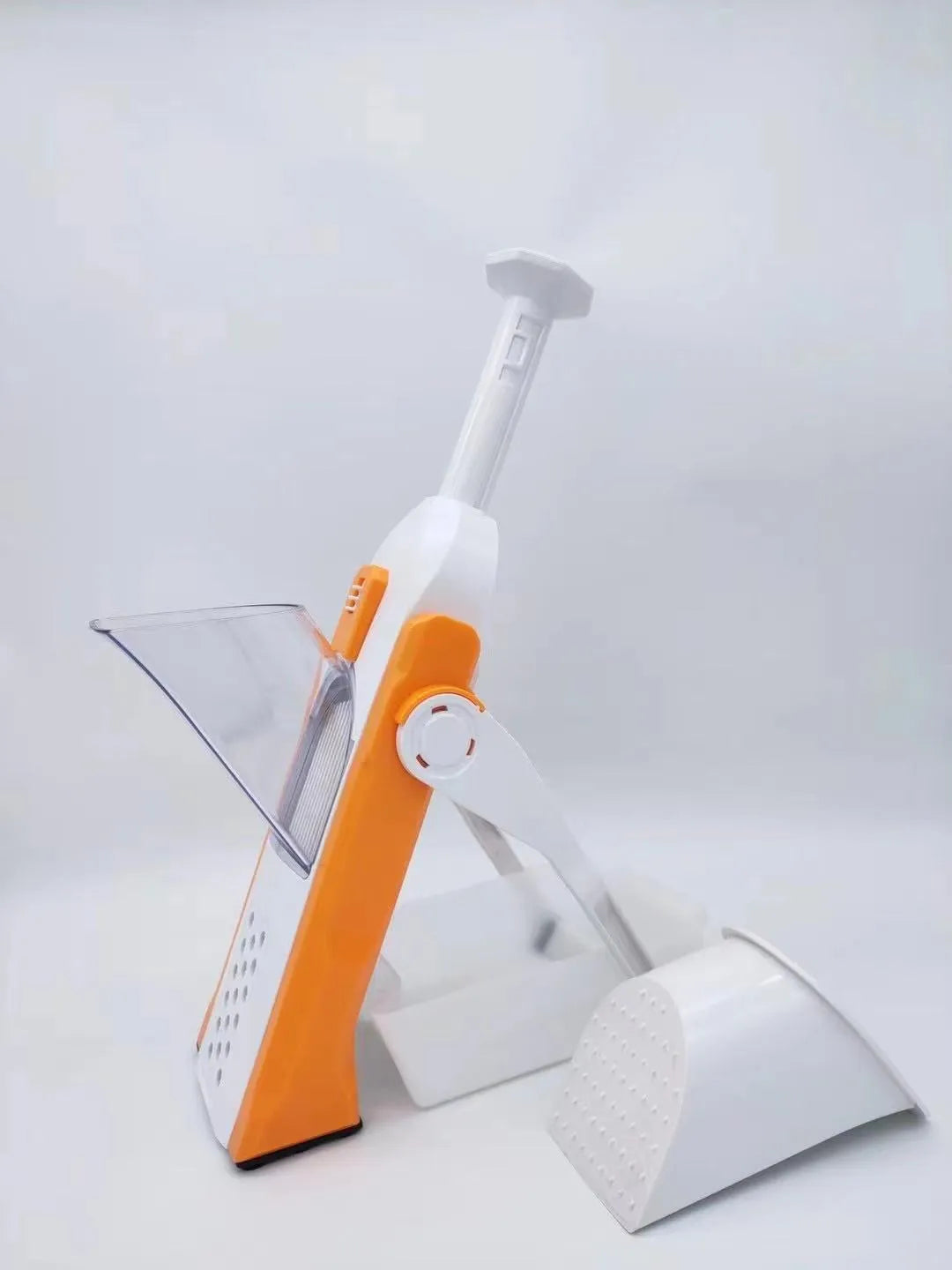 White and blue multifunctional vegetable slicer with stainless steel blades on a kitchen counter.