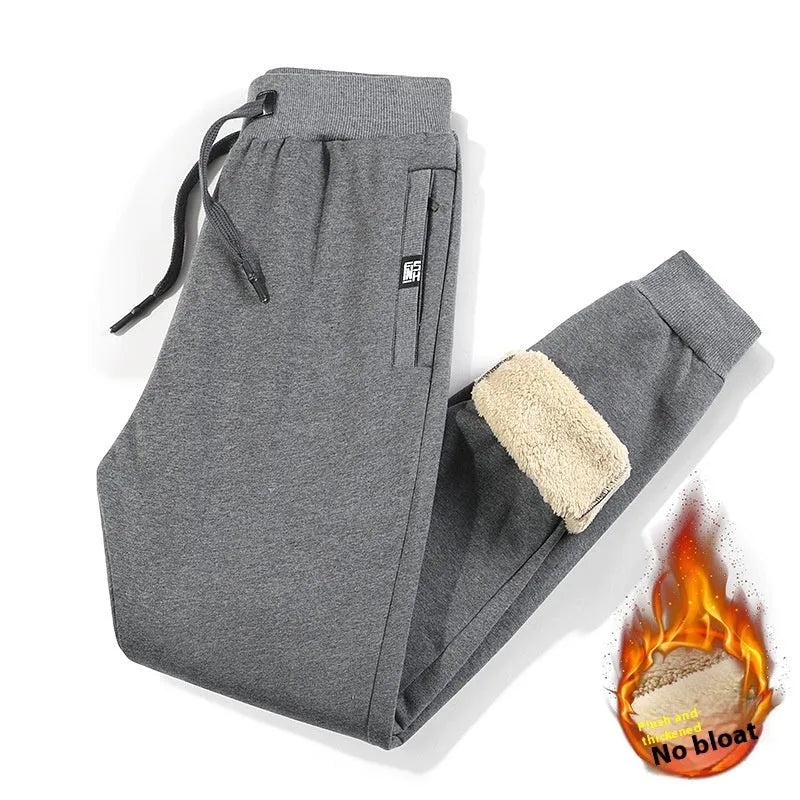 Men's grey fleece-lined oversized track pants with elastic waistband