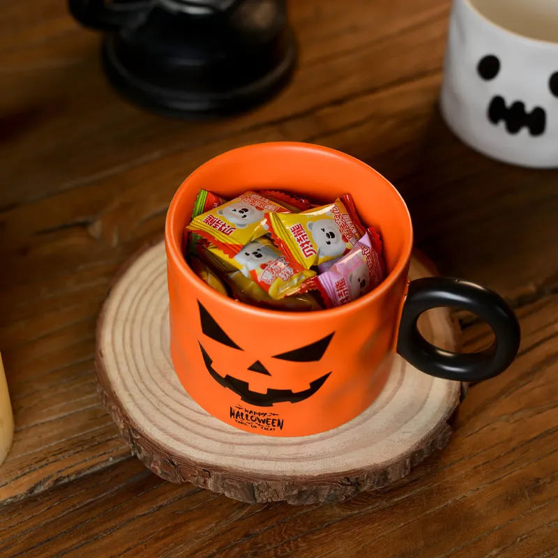Orange and white Halloween pumpkin-shaped ceramic mug with handle on a table.
