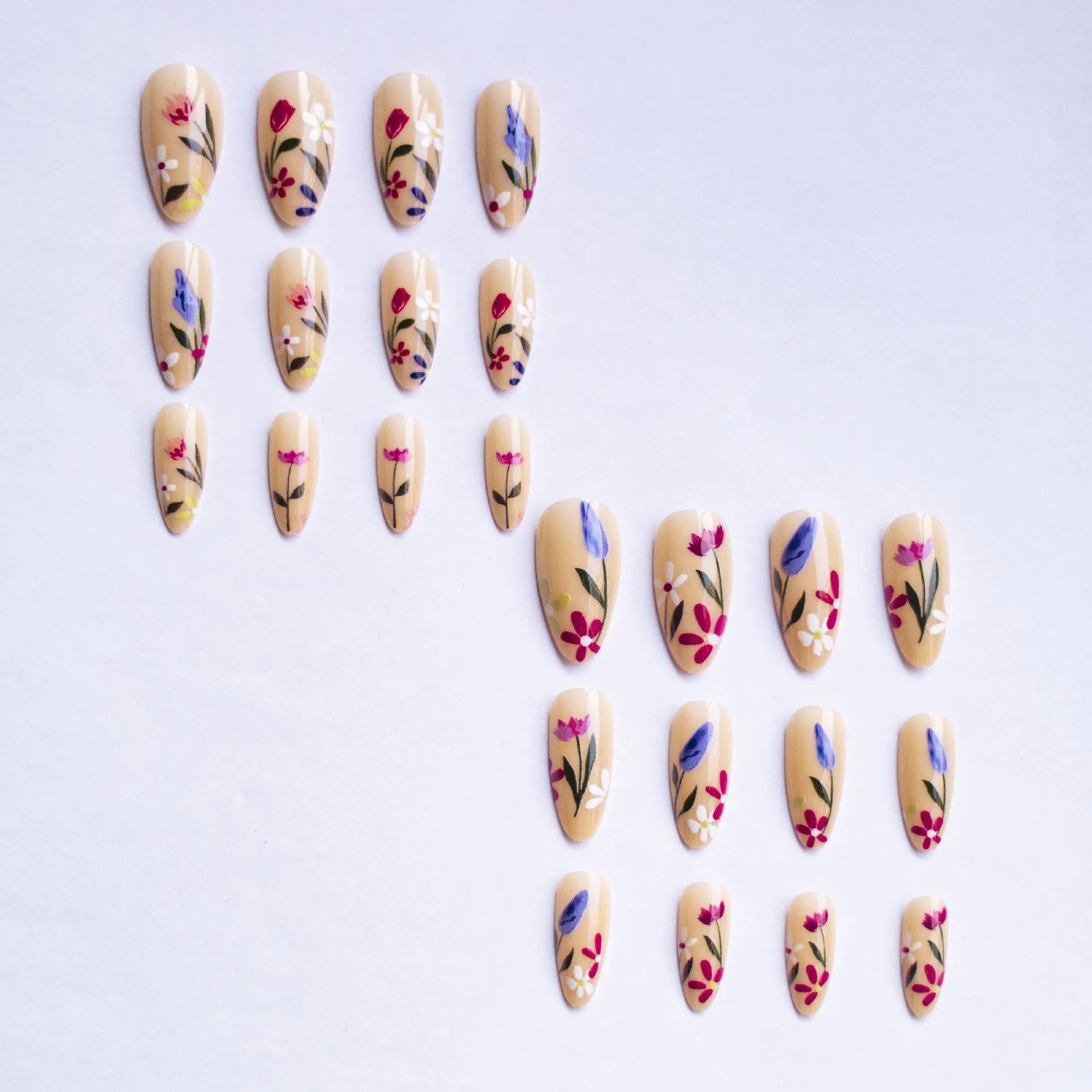 Almond-shaped removable nail art set featuring rose, tulip, and flower patterns on a hand.
