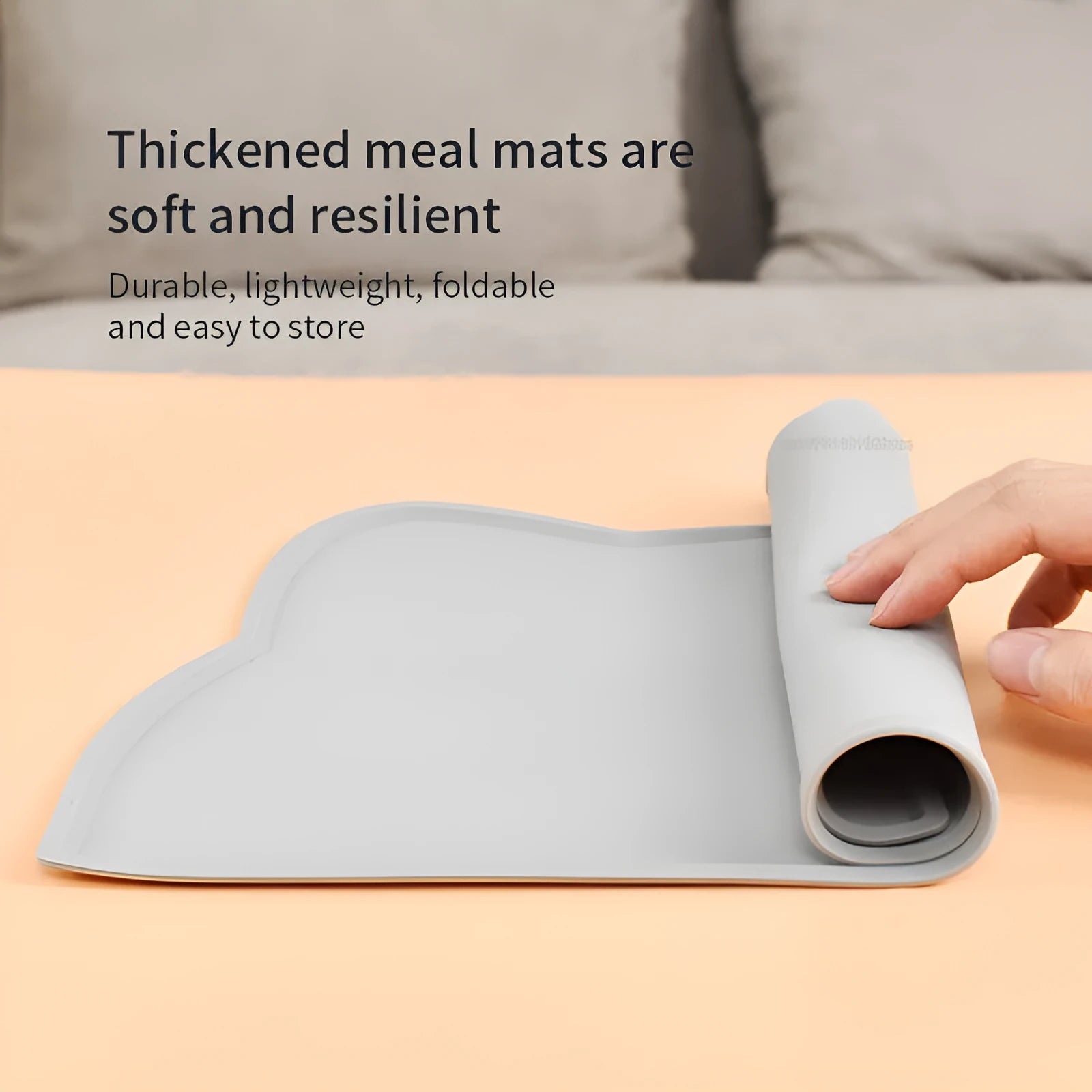 Blue silicone cat head-shaped pet feeding mat on a wooden floor