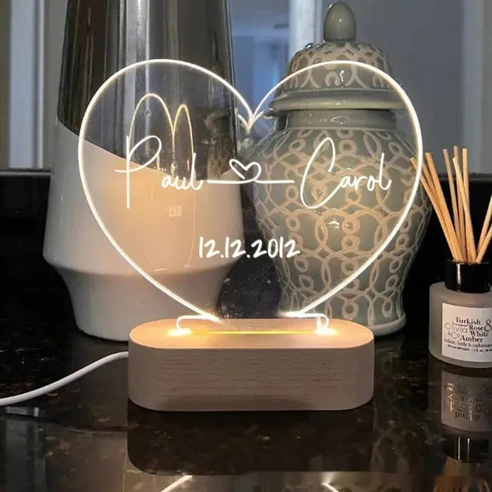 Custom acrylic LED night light with engraved names and date for Valentine's Day.