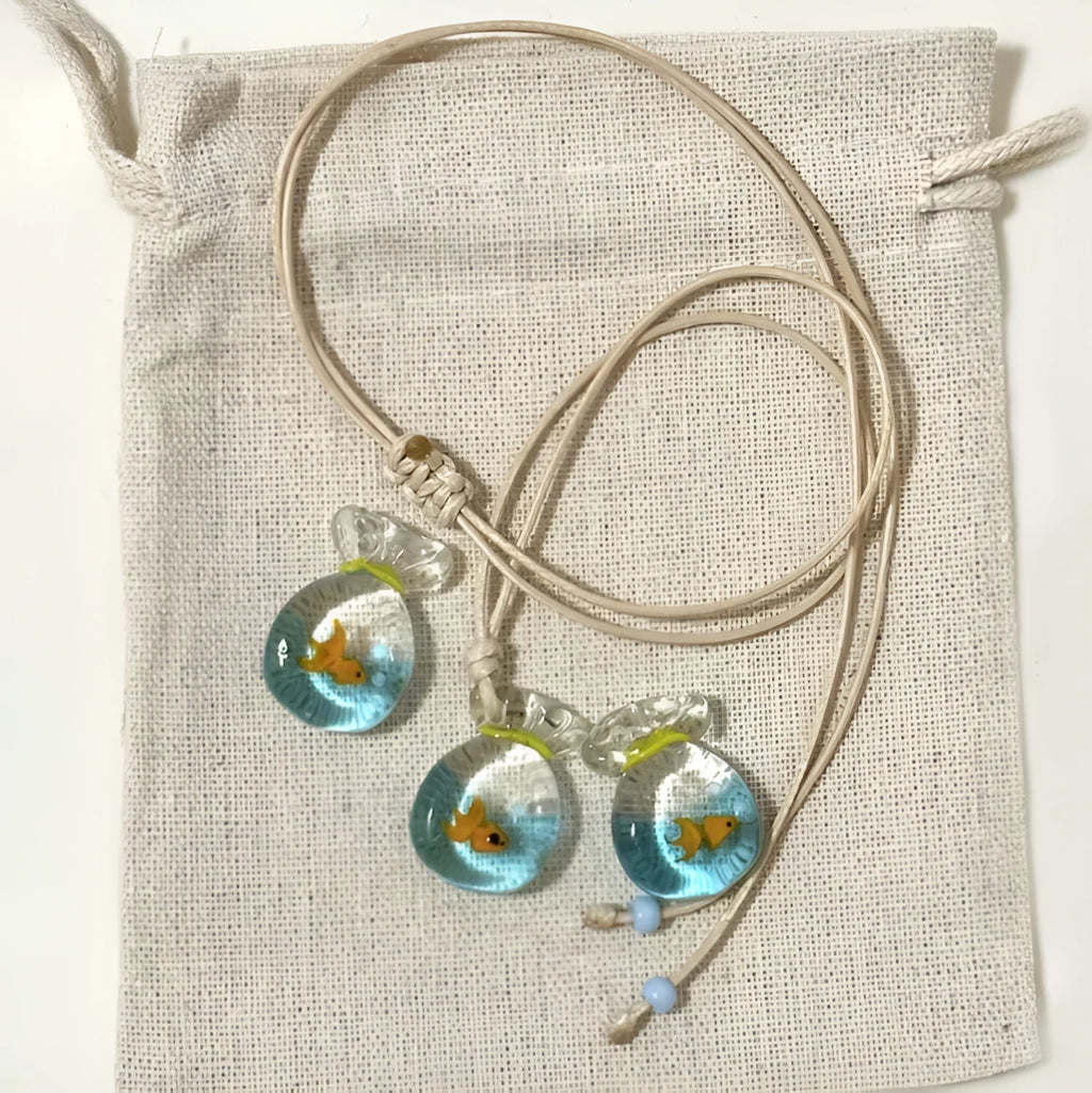 Women's necklace with coloured glaze skirt joker pendant on a beige cotton and linen chain, 45cm long.
