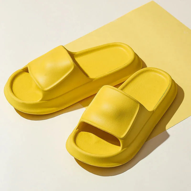 A pair of thick-soled EVA flip-flop slippers on a bathroom floor, showcasing non-slip tread and available colour options.