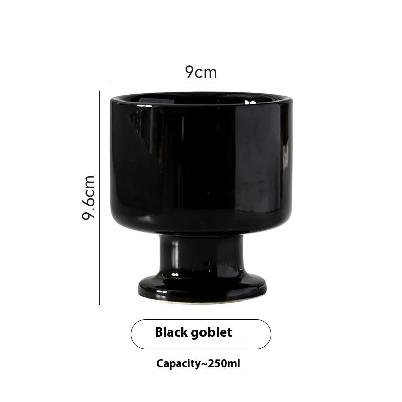 Handmade irregular solid colour ceramic mug on a table, showing its unique shape.