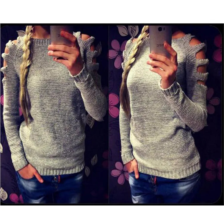 White women's knitted long sleeve shirt with hollow-out crochet detail on a hanger.