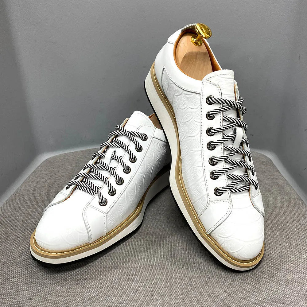Men's low-top white shoes with embossed pattern texture on the front, featuring front-tie laces.