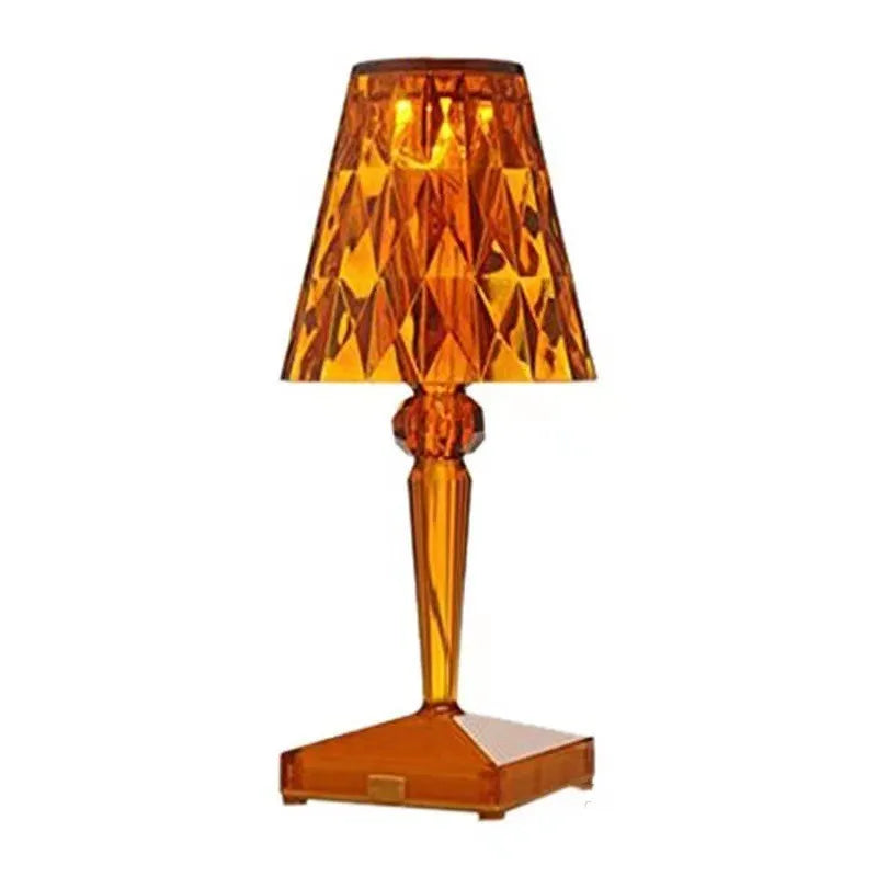 Rose gold portable touch projection night light on a surface, showing its acrylic body and dimming controls.