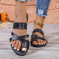 Adult round head beach slippers in black with hollow-out design and rubber sole.