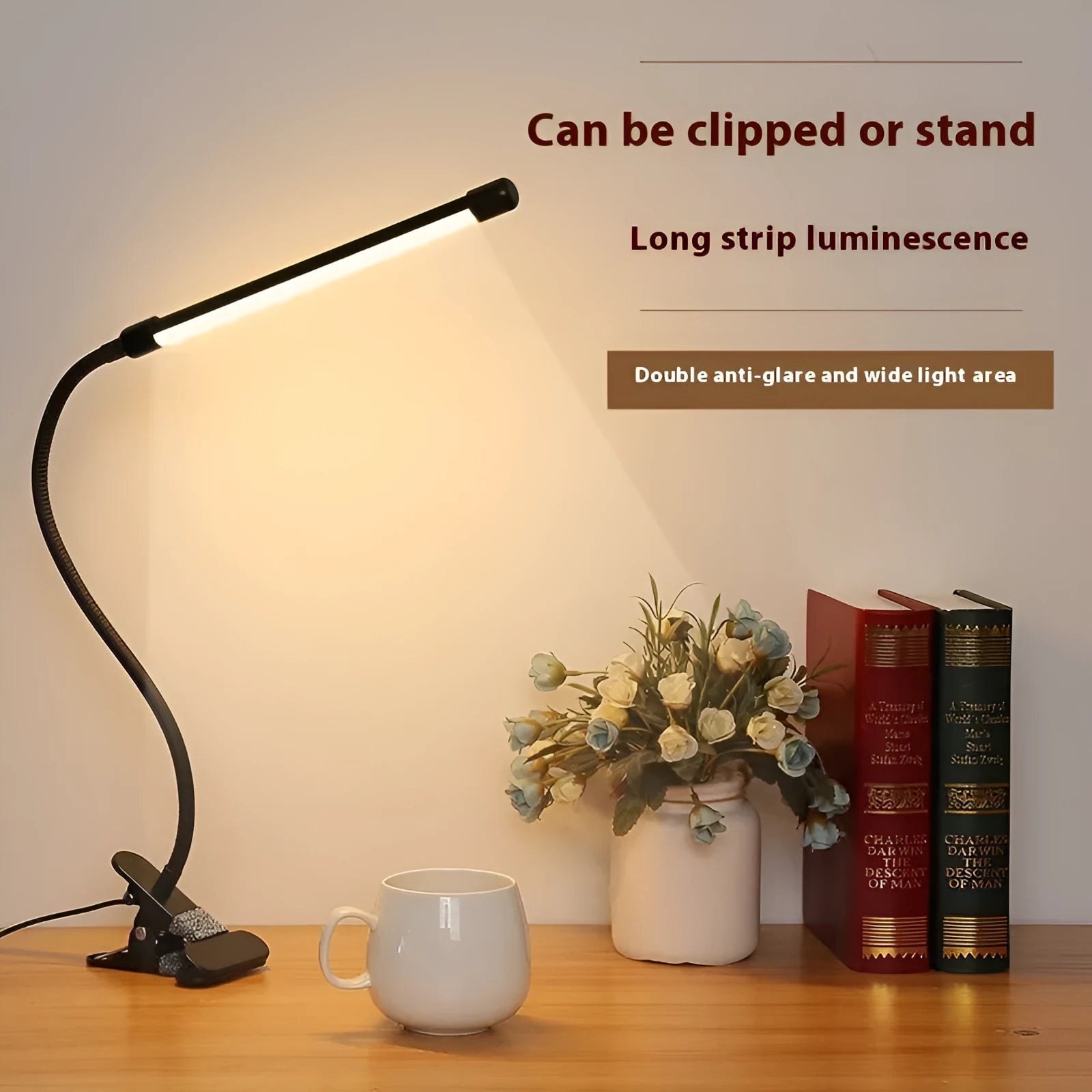 Black and white USB-powered LED desk lamp with flexible 26 cm gooseneck neck on a desk.