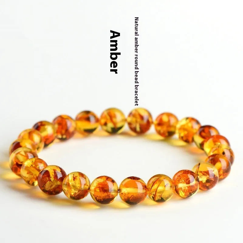 A geometric-bead amber bracelet with natural yellow piebald colouration on a wrist.