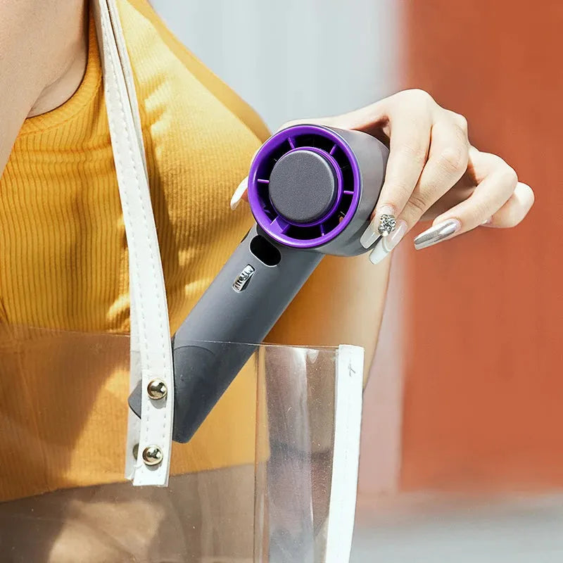 White portable handheld turbo fan with cooling function and display, shown on a table.