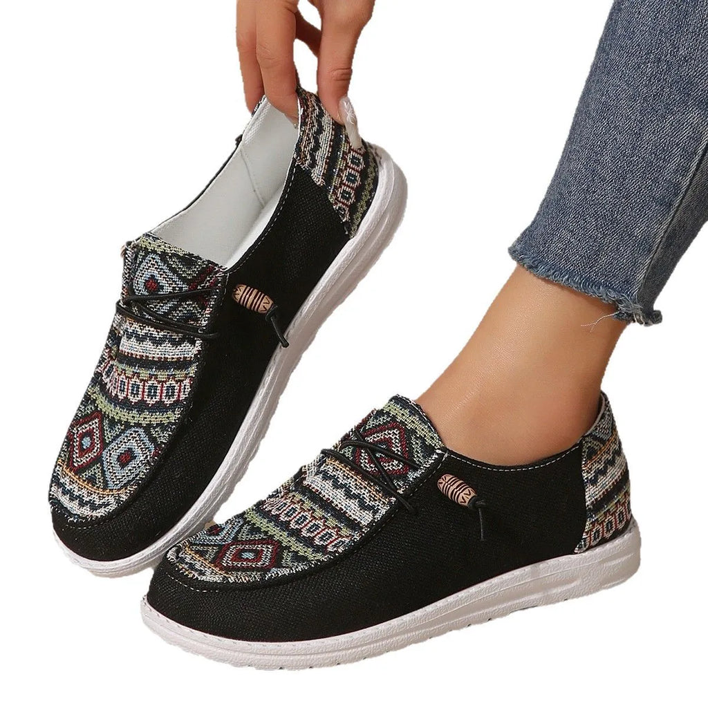 Women's black round toe low-top flat shoes with a rubber sole on a white background
