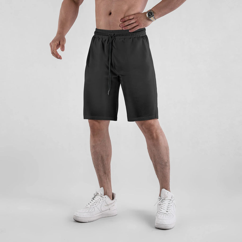 Men's black quick-dry mesh capri shorts with an elastic waistband, shown in a loose, casual fit.
