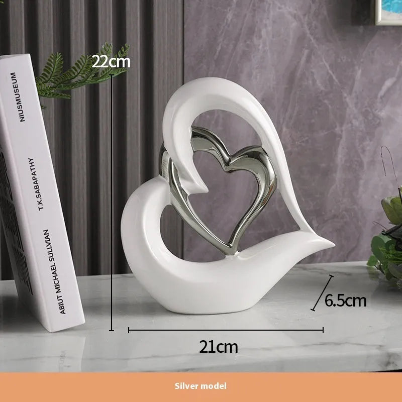 Modern geometric heart ornament in metallic finish displayed on shelf