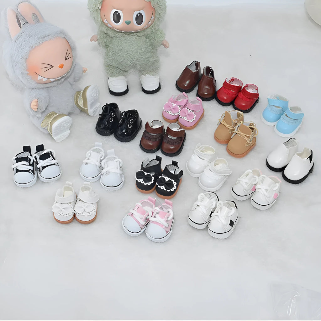 A pair of miniature PU replacement shoes for a 17cm fashion doll, shown in a selected style such as black boots.