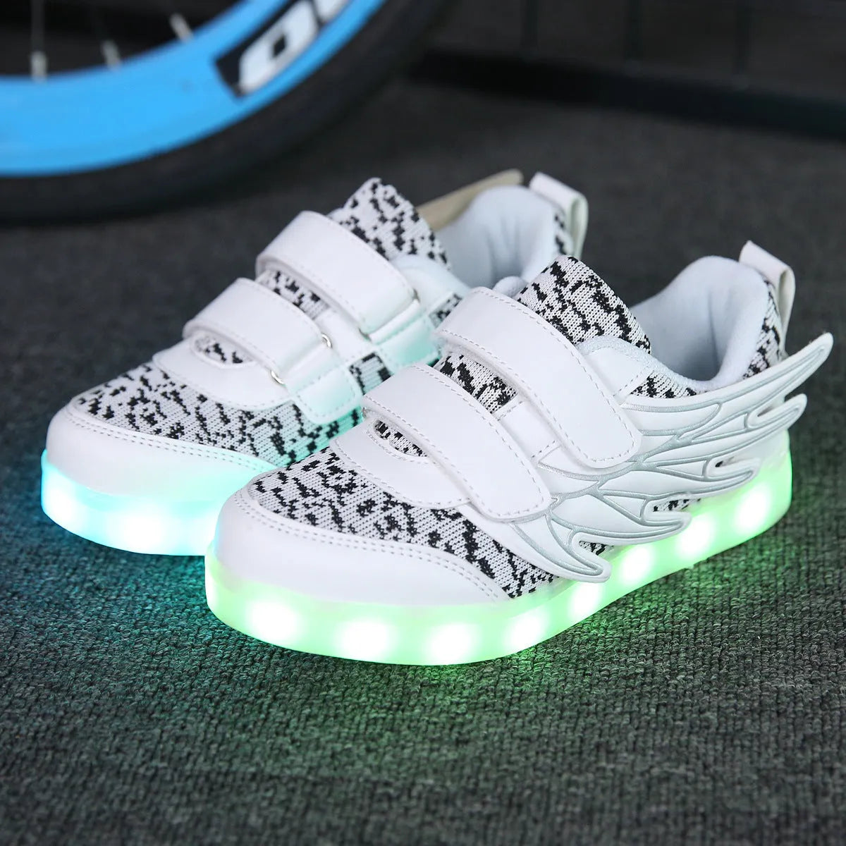 Children's plum red and white LED light-up trainers with USB charging port on the side.