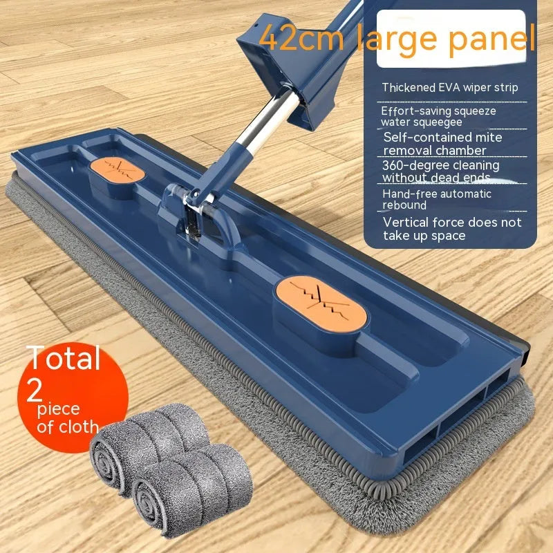 Large blue flat mop with a long stainless steel handle and a rotating head on a wooden floor.
