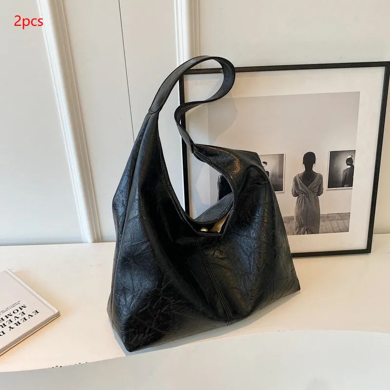 Soft PU leather large capacity shoulder bag in black with a sandwich pocket and contrasting stitching.