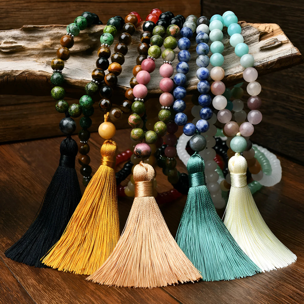 A long bohemian-style necklace with a geometric mixed gemstone pendant and a coloured tassel on a ball bead chain.
