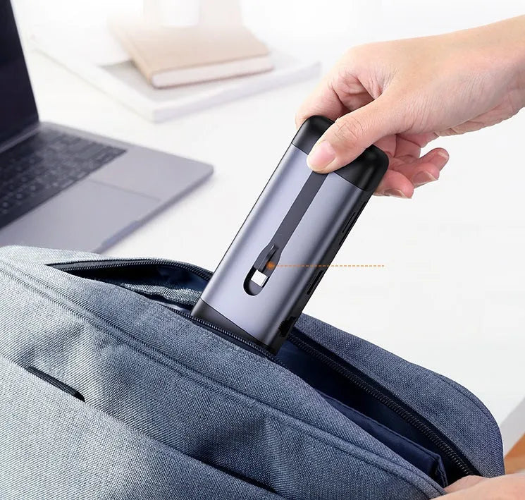 USB-C docking station hub with short cable showing HDMI, USB 3.0, PD charging, VGA, and Ethernet ports.