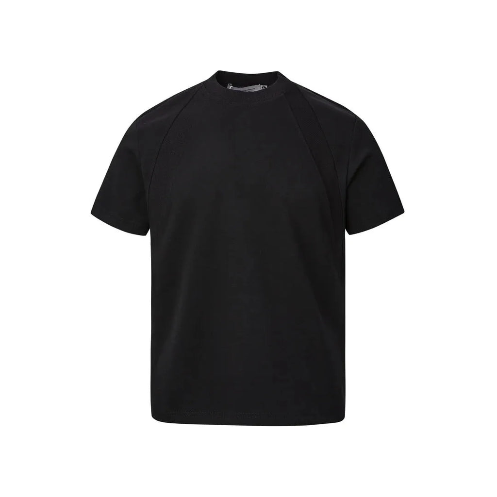 Men's loose fit short sleeve top in black with air layer stitching detail on a grey background.