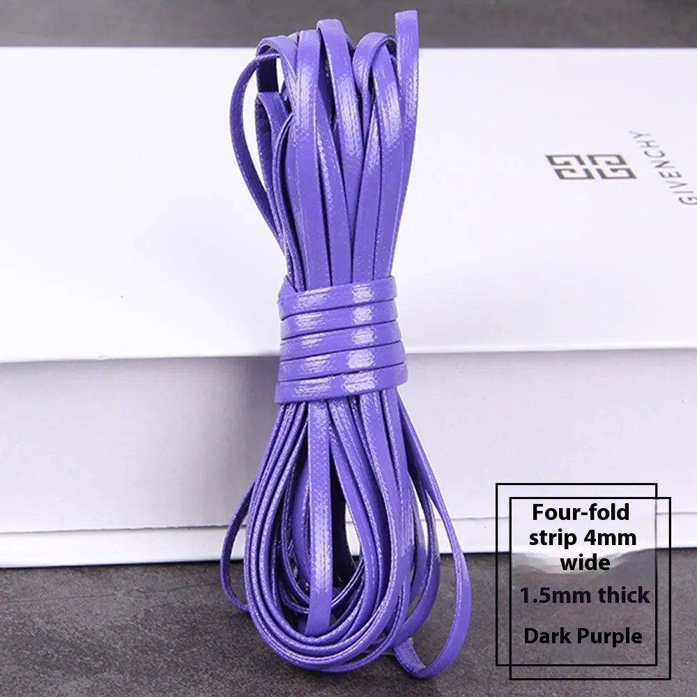 Coils of PU leather cord in multiple colours including black, brown, red, blue, and gold on a white background.