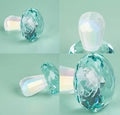 Solid resin crystal mushroom decoration in light green on a wooden surface