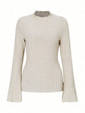 Long sleeve black top with lantern sleeves and sunken stripe texture, laid flat.