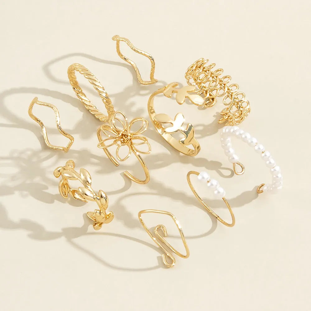 Gold colour openwork flower ring with detailed floral design and glossy electroplated finish
