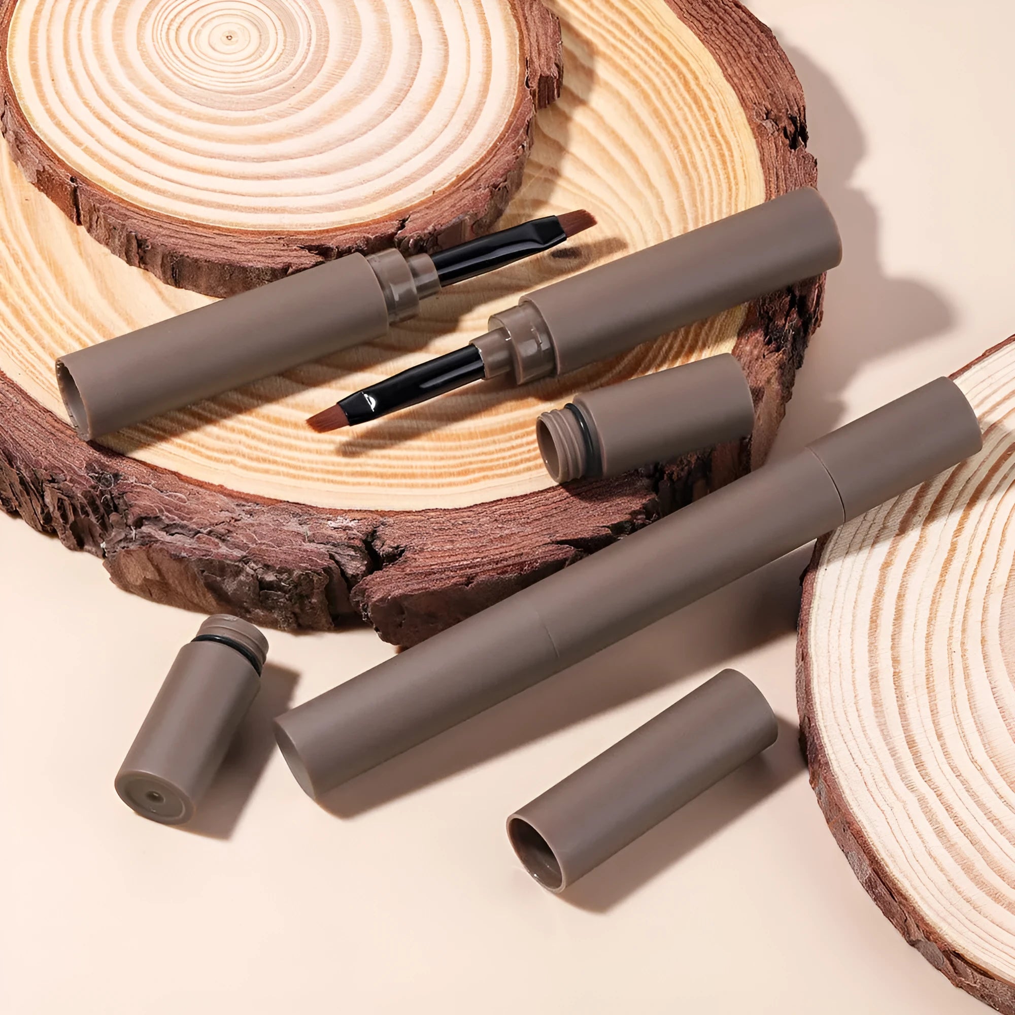 Dual-ended eyebrow cream in five colour shades including reddish brown, brown, light brown, dark brown, and black