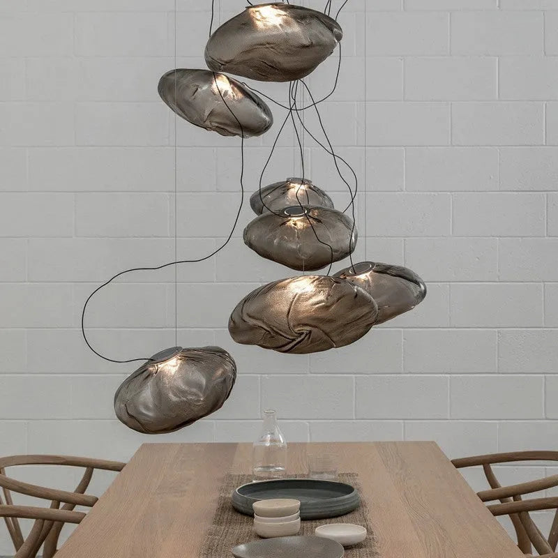 Postmodern style fabric chandelier with glass shade, shown in amber, clear, and smoke grey colours.