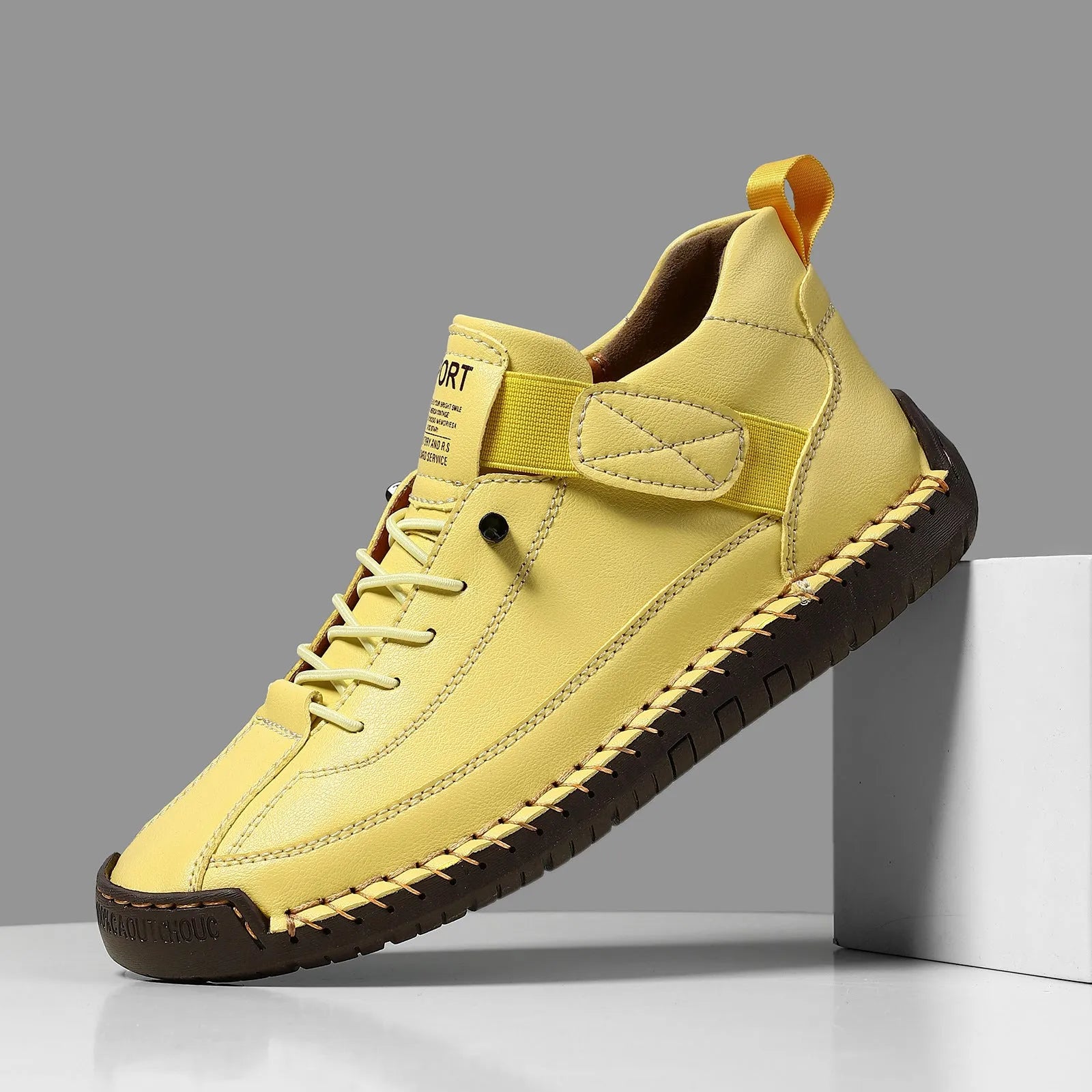 Men's mid-calf Martin boots in khaki with visible tooling stitching and an elastic band across the instep.