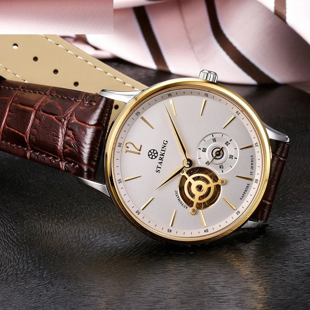 Men's stainless steel automatic watch with brown leather strap and hollow three-needle dial on white background.