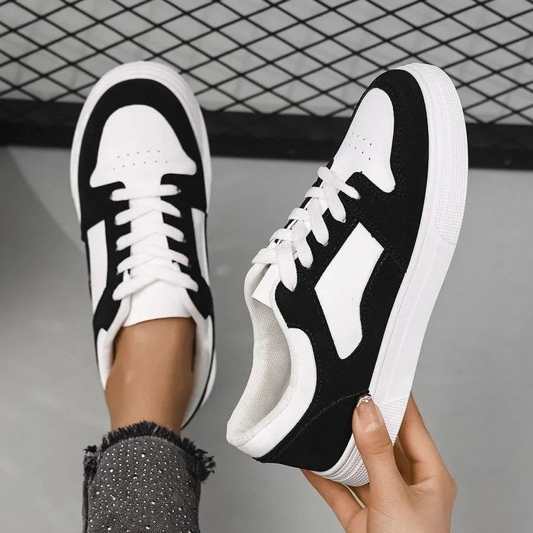 Black women's casual sports shoes with round toe, flat rubber sole, and lace-up front