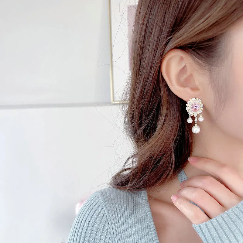 Oval geometric earrings with zircon inlay and tassel detailing in light purple colour