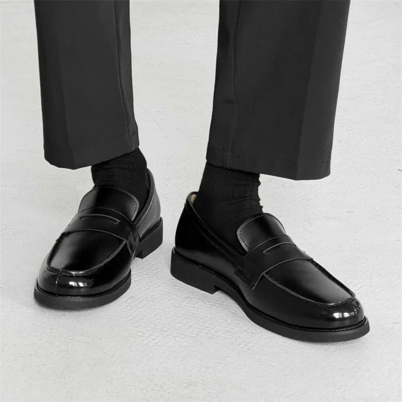 Black men's classic slip-on derby leather shoes with a rubber sole on a white background