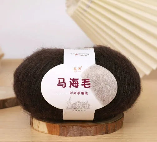 Ball of mohair yarn for DIY scarf knitting in one of 34 colours, including white, pink, blue, and green.